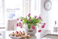 a large white porcelain jar with bright pink tulips is a bold spring centerpiece that looks fresh and romantic