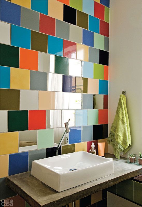 a modern bathroom accented with colorful tiles over the sink is a bright and unexpected solution that wows