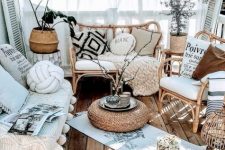 a neutral boho porch with rattan furniture and candle lanterns, lights, potted plants, pillows and textiles