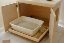 a plywood box with doors and a comfortable wheeled tray plus an entrance is great for a modern space