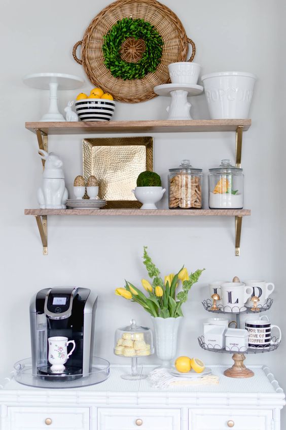 a striped bowl with lemons, a greenery wreath, yellow tulips in a white vase is cool spring kitchen decor