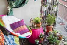a tiny colorful boho balcony with a black rug, a neon green bench, a multicolor chair, lots of potted plants and cacti, some pillows