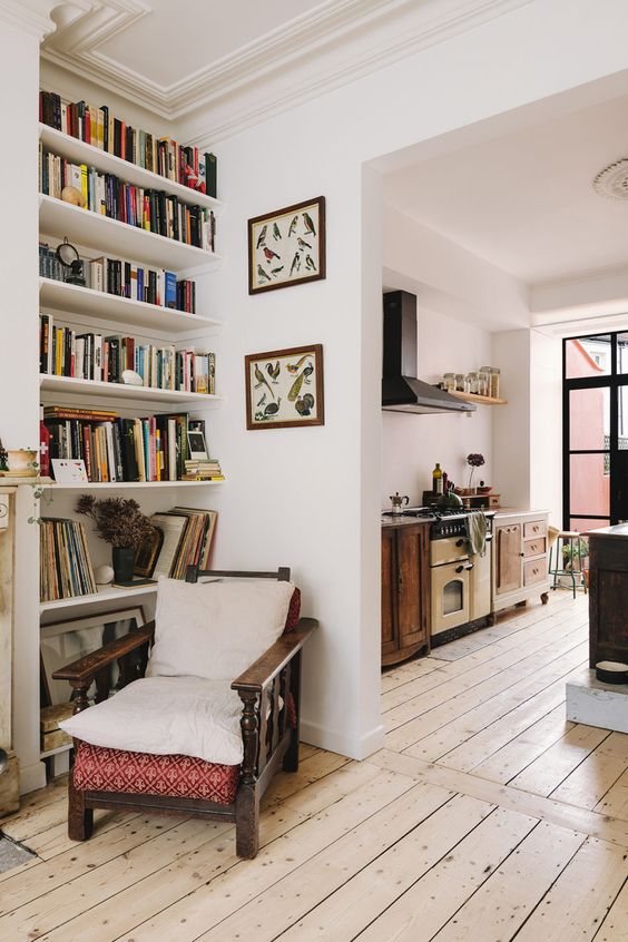 a welcoming reading nook with built-in shelves and a vintage chair with pillows is perfect for spending time here