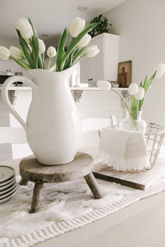 a white jug and a clear vase with some white tulips are nice spring decorations to rock, they will bring a casual feel to the space