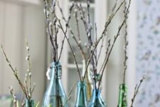 blue and green bottles and vases with willow make a natural and cool spring decoration or Easter centerpiece