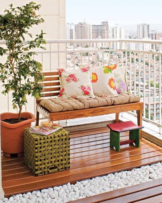 cheerful printed pillows and a pink footrest will immediately bring a fresh spring feel to the balcony