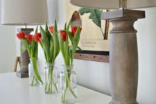 clear bottles with red tulips is a simple and modern spring arrangement with bright touches of color