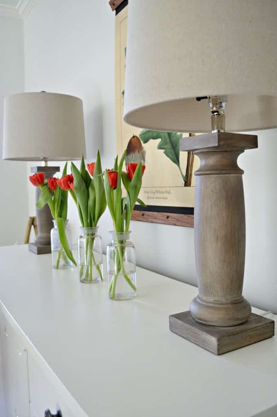 clear bottles with red tulips is a simple and modern spring arrangement with bright touches of color