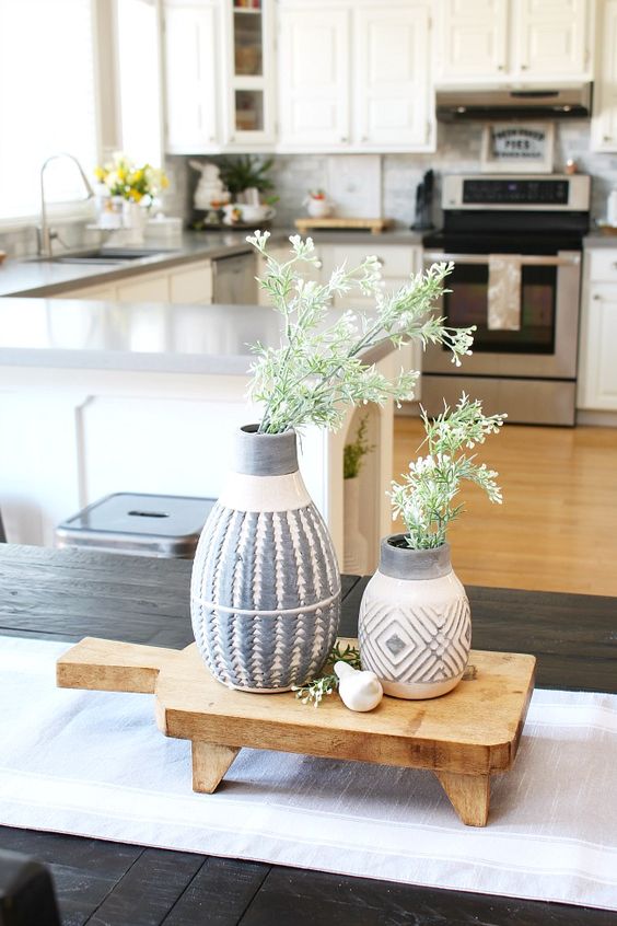fresh greenery in printed vases on a wooden board will give a slight spring feel to your kitchen