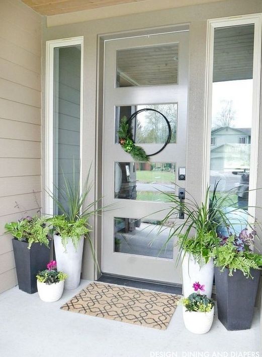 potted greenery, bright blooms and a greenery wreath for a bright spring porch