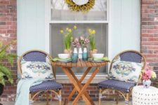 printed pillows and a blanket, potted blooms and tulips in vases, a bright floral wreath