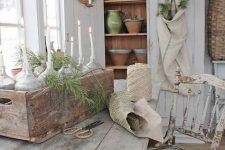 a Scandinavian farmhouse space with a whitewashed storage cupboard, a whitewashed table and a whitewashed and distressed chair