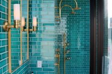a chic modern bathroom with turquoise tiles, a white free-standing sink, mirrors and touches of gold