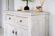 a delicate whitewashed credenza is a lovely idea not only for a vintage or farmhouse space but also for many others, too