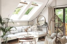 a neutral boho attic living room with skylights, beams, a suspended chair, wooden coffee tables