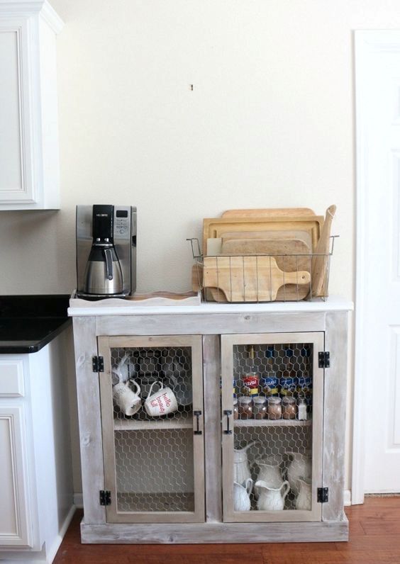 a simple vintage and rustic whitewashed cabinet with chiken wire doors is a lovely idea for a kitchen, a dining room or some other space