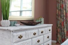 a vintage whitewashed dresser with elegant gold knobs is a very chic and stylish idea for a bright bedroom