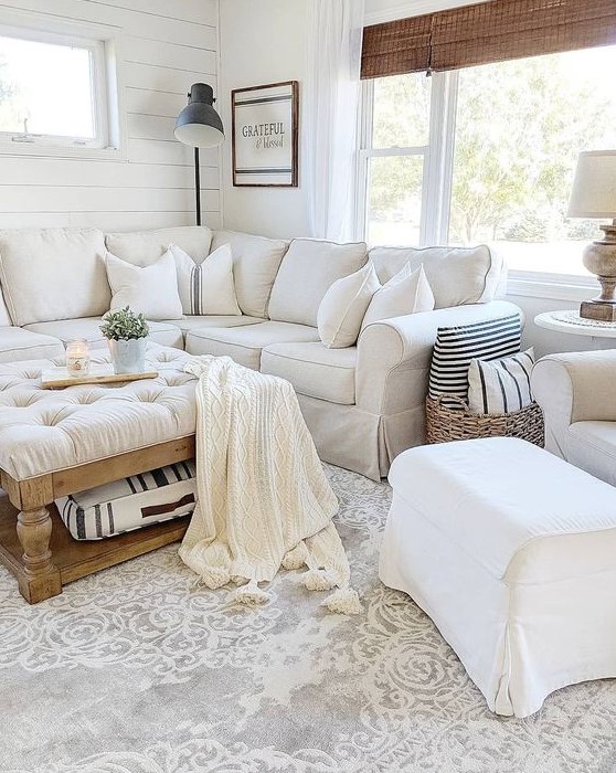 a white farmhouse living room with a sectional Ektorp, a white chair and footrest, a low tufted ottoman