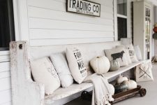 a cozy white porch design in farmhouse style