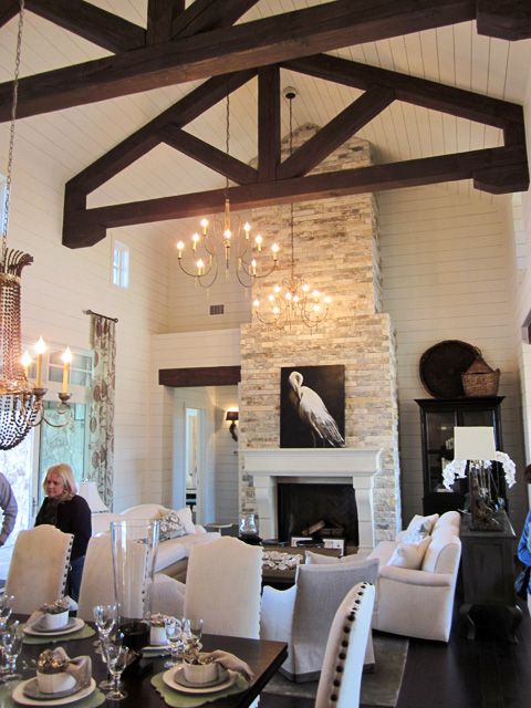 a whitewashed stone fireplace with an elegant white mantel and an artwork makes a statement in this farmhouse space