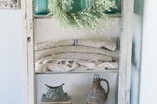 an antique whitewashed farmhouse storage unit with a net door is a beautiful idea for a vintage or shabby chic space