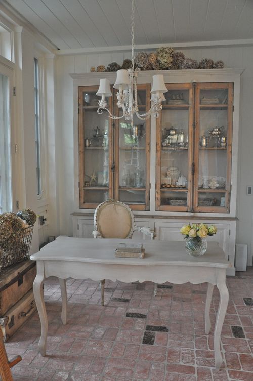 an oversized whitewashed storage unit with glass doors is a beautiful solution for any shabby chic or vintage room