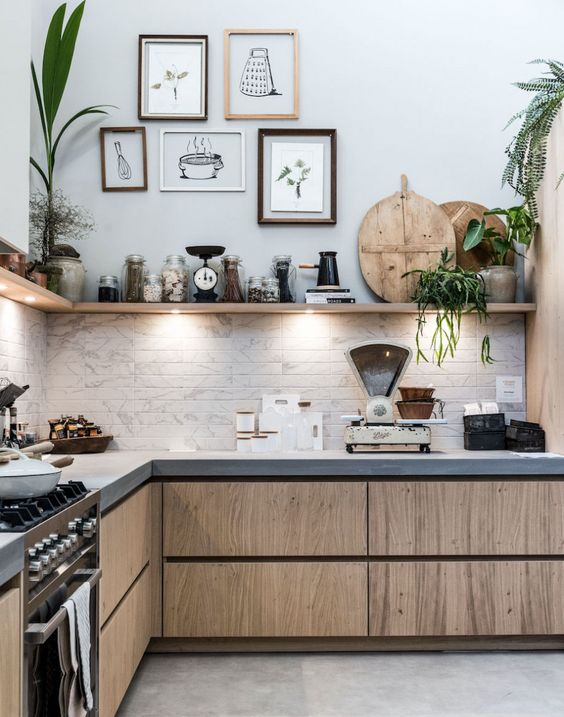 a catchy modern kitchen with sleek cabinets, concrete countertops and marble tiles on the backsplash
