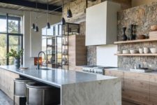 a contemporary chalet kitchen with a stone wall, a reclaimed wood ceiling, stone countertops and a modern black chandelier