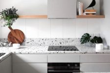 a minimalist grey kitchen with grey terrazzo countertops that add an eye-catchy touch