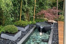 pebbles and rocks, a stone fountain, grasses in flower beds are amazing to complete a zen-like front yard