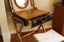 a creative mini makeup table of a vintage suitcase, a mirror and a tabletop can be DIYed if a usual vanity isn’t your thing