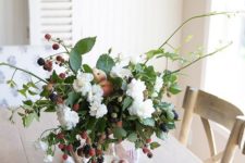 a fresh summer centerpiece or arrangement with white blooms, peaches and berries is a beautiful idea