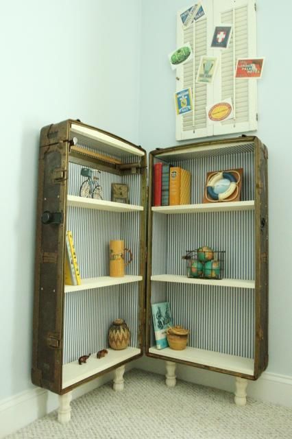a large vintage suitcase placed on legs is used for storage and displaying things in it and is a very catchy idea