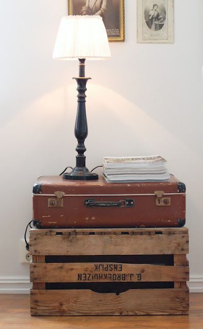 a side table composed of a vintage crate and a vintage suitcase, with a lamp and some books is a lovely idea for a modern space