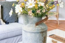 a vintage metal milkpot with wildflowers is a cool summer decoration for any space and it will add a rustic feel