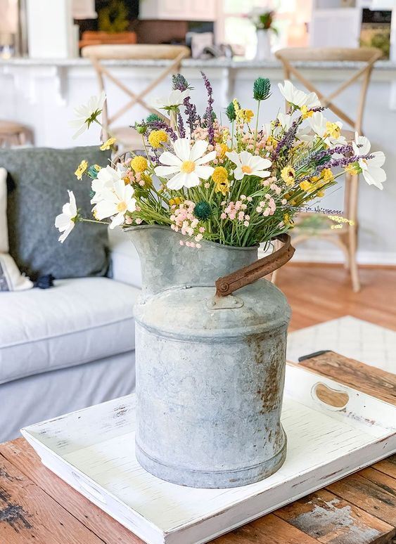 a vintage metal milkpot with wildflowers is a cool summer decoration for any space and it will add a rustic feel