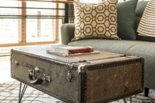 a vintage suitcase placed on hairpin legs is a very beautiful side table with plenty of storage space