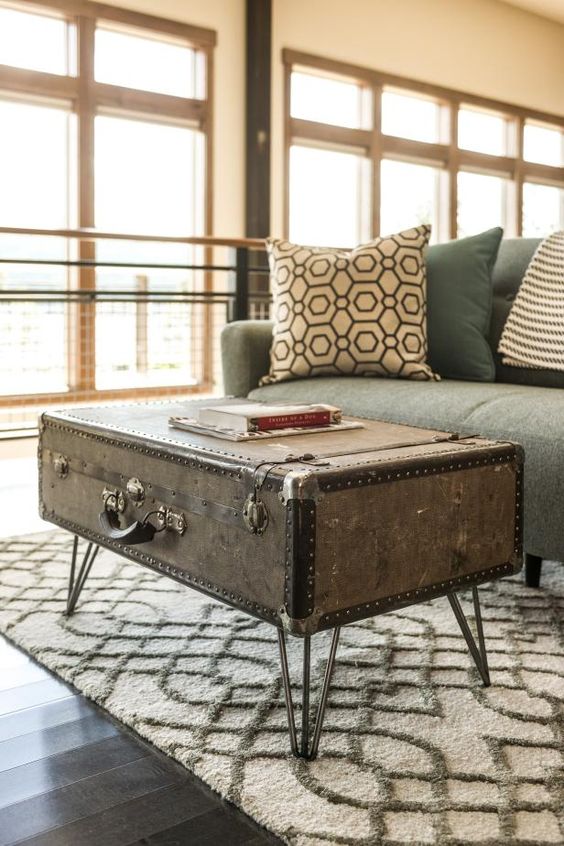 a vintage suitcase placed on hairpin legs is a very beautiful side table with plenty of storage space