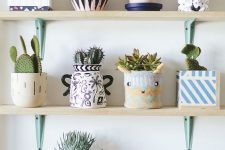 a whole arrangement of bright and fun planters of various patterns, looks and colors and cacti and succulents
