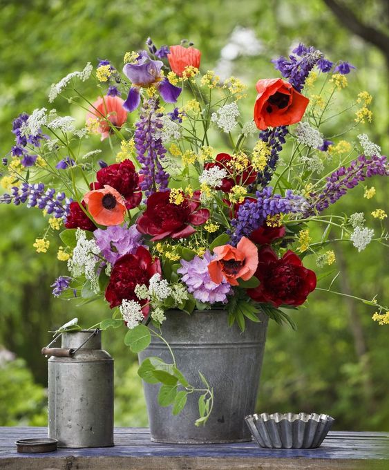 place your colorful floral arrangement into a simple metal bucket to make your summer decor bright and fun