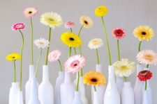 white bottles with colorful gerberas for a modern and bold summer decoration that is easy to compose