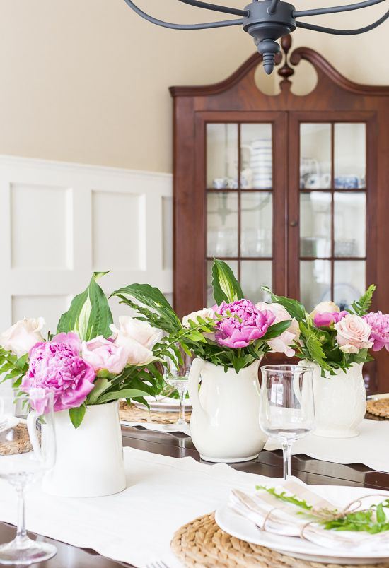 white porcelain milk jugs with hot pink and blush blooms are a lovely rustic summer decoration