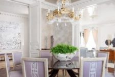 a beautiful metallic ceiling, a round table and lilac chairs create a lovely look, and a gold crystal chandelier adds to it