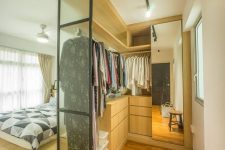 a bedroom with a walk-in closet is a fantastic idea, you can make a sleeping space on a platform and a closet with a large mirror and sleek drawers