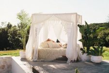 a boho-styled outdoor bedroom under a canopy may be enough to relax and to protect you from the sun