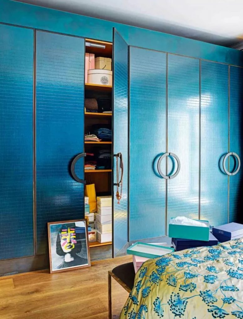 a bold bedroom with a gorgeous teal wall-to-wall wardrobes, black handles that s a very chic and cool idea for a bright space