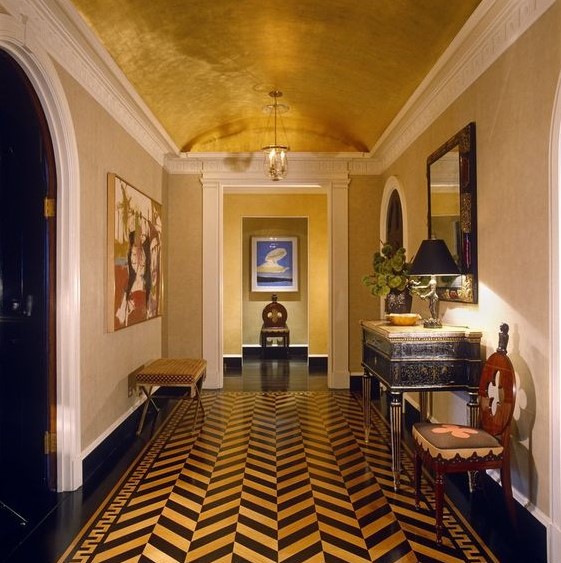 a bold mid century modern foyer with a metallic arched ceiling and a bold chevron floor