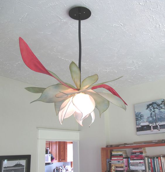 a bold statement flower shaped chandelier in green, blush and red is very chic and cool for whimsy decor