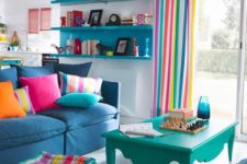 a bright living room with striped curtains, a matching ottoman, colorful pillows and some bold furniture for fun