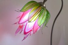 a colorful table lamp that shows off a predator flower in hot pink and green is a cool and bright idea